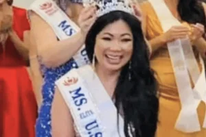 Sacramento beauty queen admits $10M investment fraud funding gambling trips. Asian woman wearing a crown and “Ms. U.S.” sash smiling on stage during a pageant while people behind her clap and celebrate.
